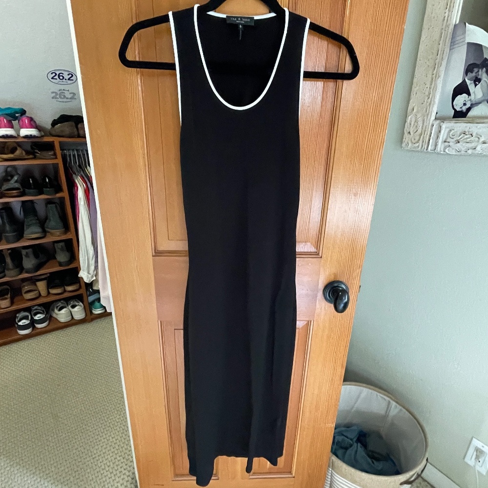 New black calf length, sleeveless, open back dress with white piping detail